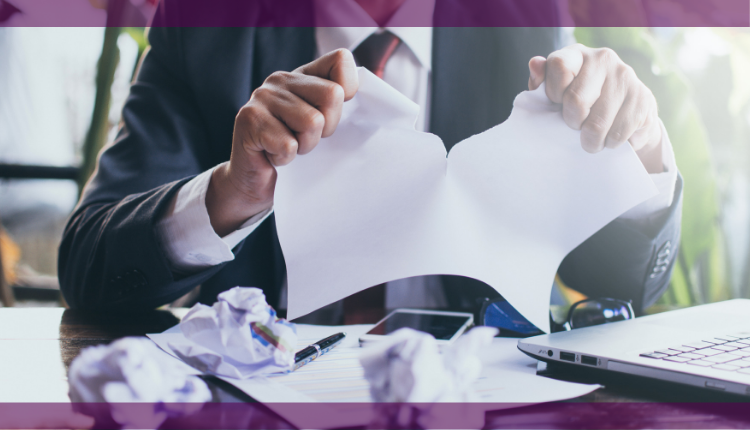 man tearing up contract in commercial dispute leading to commercial litigation