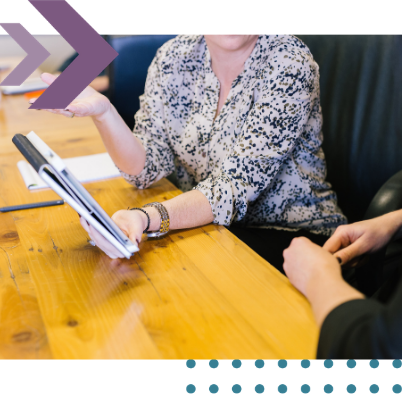 Employment solicitor reviewing an employment contract with a client at an office desk